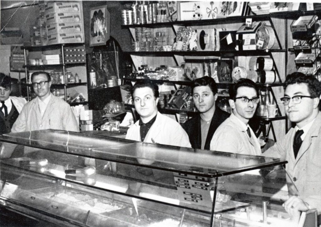Black and white photograph of Italians behind the counter of the Rainbow Cafe in Coatbridge
