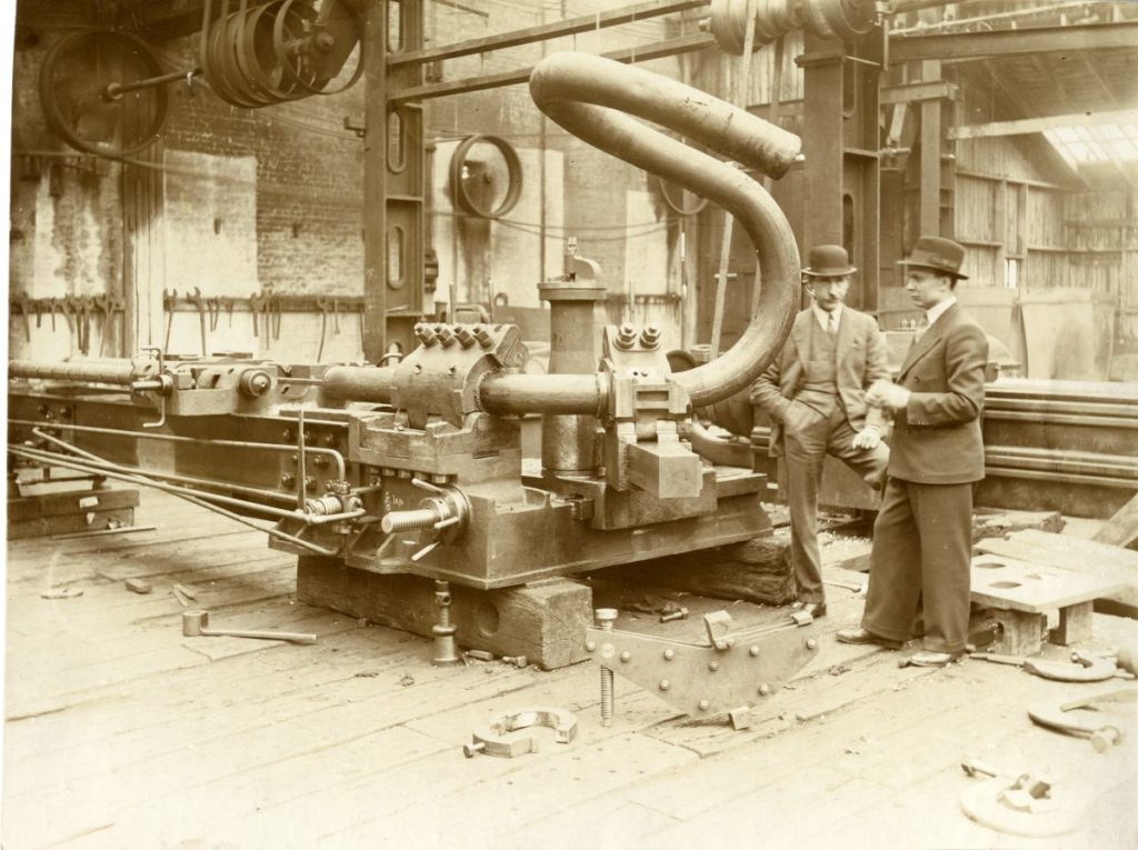 Testing a new pipe bending machine in Murray and Paterson's works, Coatbridge. About 1930.