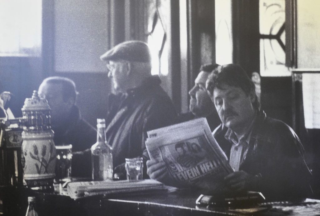 Black and white image of three men sitting in the Horseshoe Bar, Motherwell c.1995
