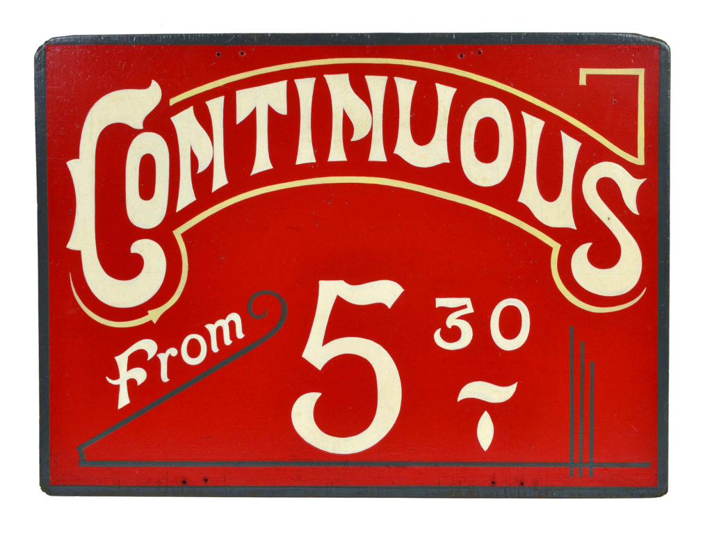 Vintage cinema sign bearing the words 'Continuous from 5.30' in white lettering against a red background